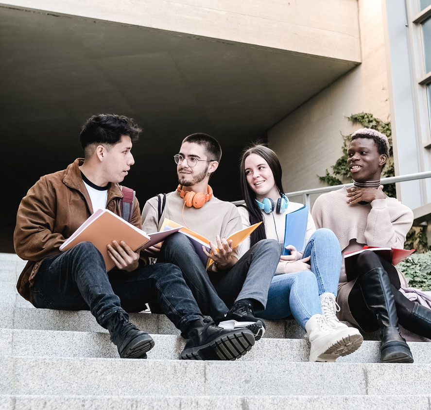 Multiethnic students discussing homework on steps