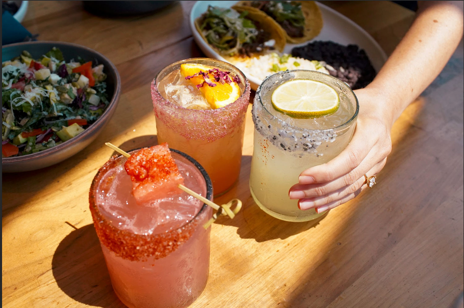 Colorful cocktails on a wooden table during San Diego Restaurant Week